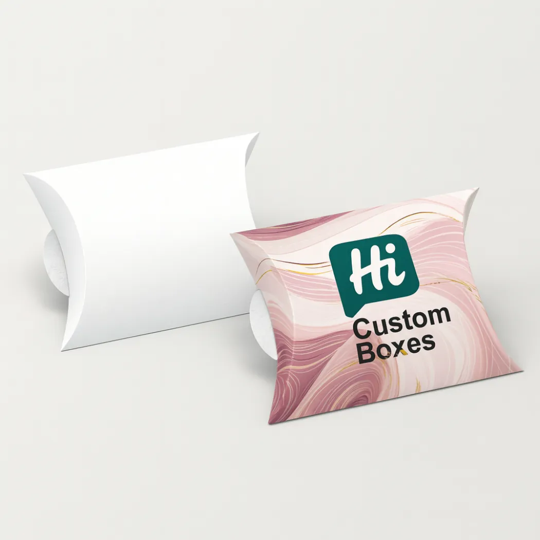 Two pillow-shaped boxes- one plain white and one with pink marbled designs and branding- class=